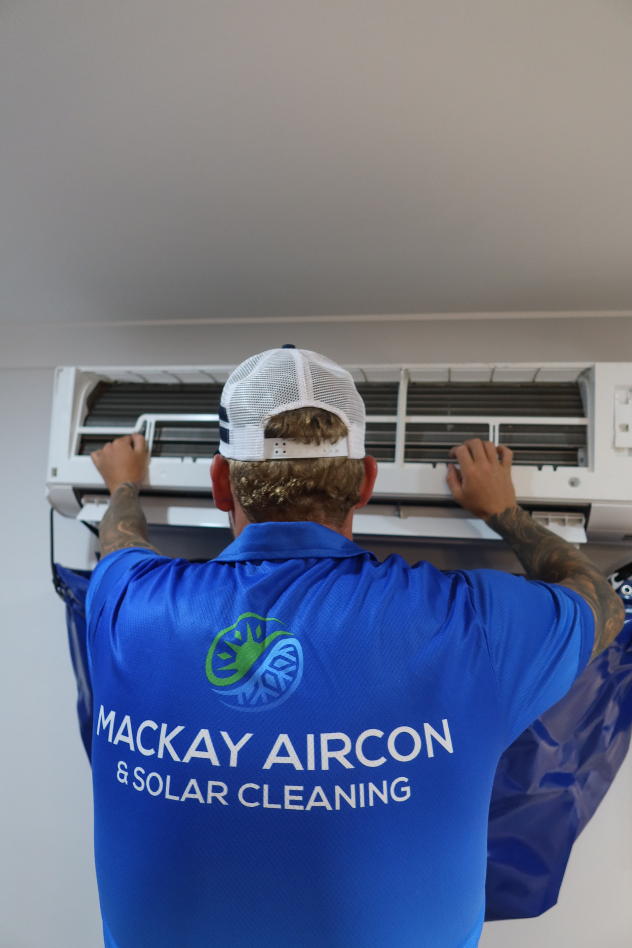 Catch bag fitted under a split system air conditioner before cleaning